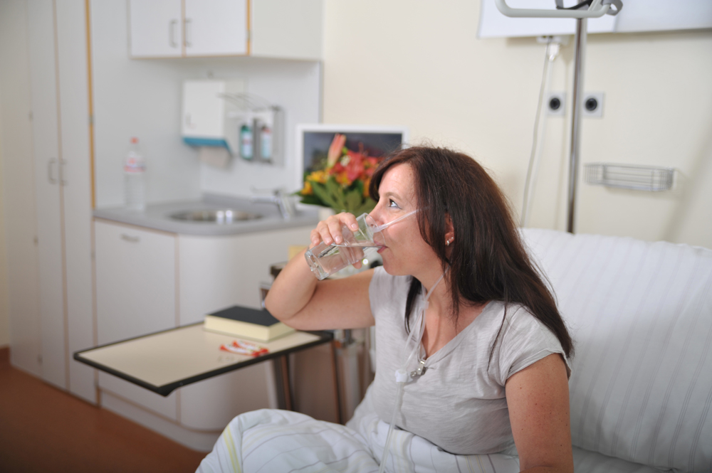 Woman drinking during nasal application.